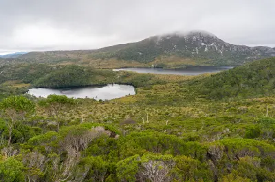 Alpine lakes surrounded by mountain vegetation beneath low cloud near Cradle Mountain, Tasmania.
