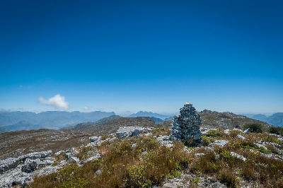 Rock cairn on the Perdekop and Du Toitskop hiking route in Mont Rochelle Nature Reserve overlooking the Franschhoek mountains in South Africa.