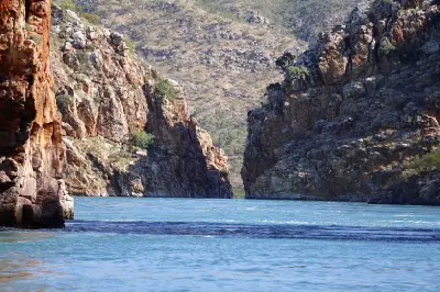 Tidal water surges toward the narrow gap between rugged rock walls at Horizontal Falls in Talbot Bay.