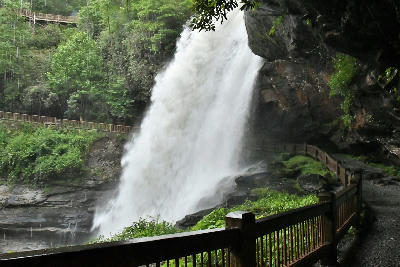 Side view of Dry Falls with the walking path passing behind the waterfall in Nantahala National Forest, North Carolina.