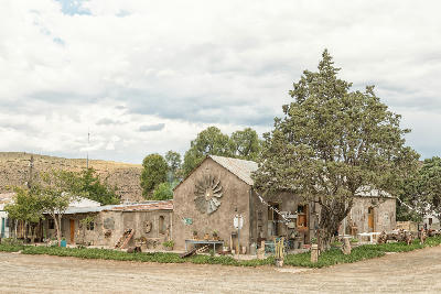 Historic Karoo building decorated with vintage farm items in Nieu-Bethesda, Eastern Cape, South Africa.