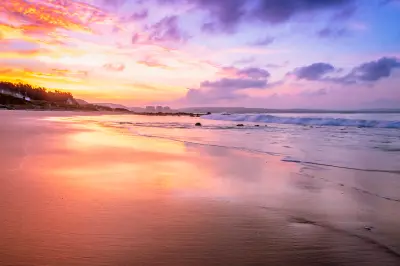 Pastel sunset light reflects across the shoreline at Diaz Beach, one of Mossel Bay's most popular oceanfront beaches along the Garden Route.