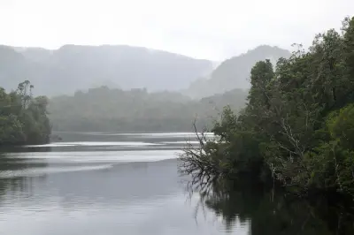 Gordon River winding through misty rainforest and mountains in western Tasmania.
