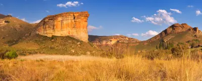 Brandwag Buttress illuminated by late afternoon sunlight in Golden Gate Highlands National Park, with golden grasslands and layered sandstone mountains in the eastern Free State, South Africa.