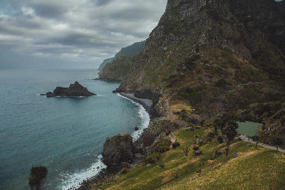 Volcanic cliffs and Atlantic coastline seen from Miradouro de São Cristóvão on Madeira Island, Portugal.
