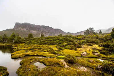 Alpine wetlands and the Pool of Bethesda beneath rocky cliffs in Walls of Jerusalem National Park, Tasmania.