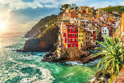 Sunset over Riomaggiore in Cinque Terre National Park, with warm light across the Ligurian coastline in La Spezia, Italy.