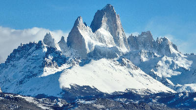Snow-covered Mount Fitz Roy with clear blue sky in Patagonia, Argentina.