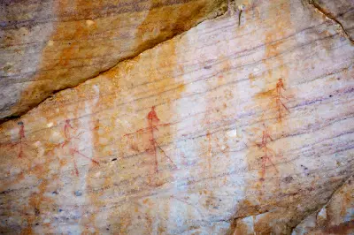 Faint San rock art figures painted on a sandstone shelter wall near the burial site of Dr. C. Louis Leipoldt in the Cederberg Mountains, Western Cape, South Africa.