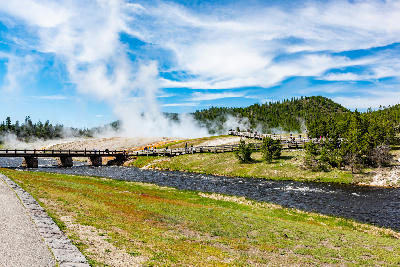 Boardwalk and bridge crossing the Firehole River in Midway Geyser Basin on the approach to the Grand Prismatic Spring Overlook