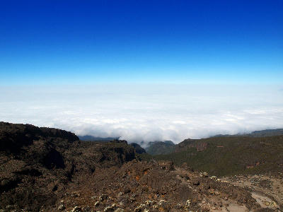 Sea of clouds stretching below the Barranco Wall on Mount Kilimanjaro, Tanzania, viewed from approximately 4,130 metres above sea level.