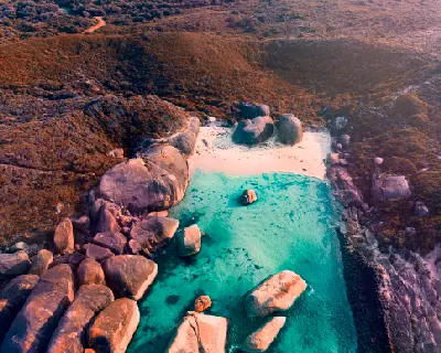 Aerial view of Elephant Cove with turquoise water, white sand and giant granite boulders near Denmark, Western Australia.