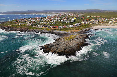 Drone view of Yzerfontein showing granite coastal headlands, sandy beaches, residential areas and the Atlantic coastline on South Africa's West Coast.