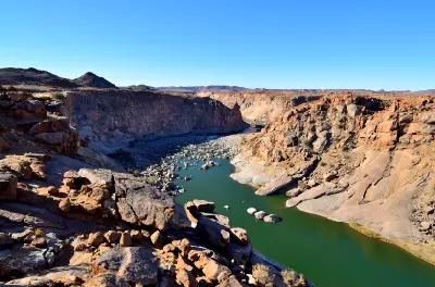 The Orange River flows through a deep granite canyon viewed from Ararat Viewpoint in Augrabies Falls National Park, South Africa.