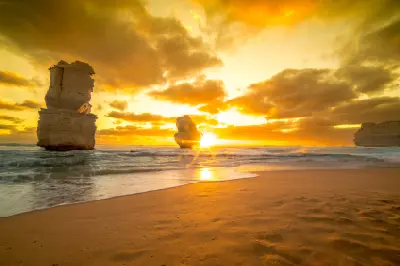 Golden sunset over limestone sea stacks and Gibson Steps Beach, Port Campbell National Park, Victoria, Australia.