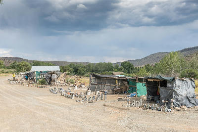 Curio stalls and handmade craft displays near the entrance to the Owl House in Nieu-Bethesda, Eastern Cape, South Africa.