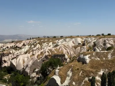 Eroded volcanic rock formations and cave openings across Pigeon Valley, Cappadocia, Turkey.