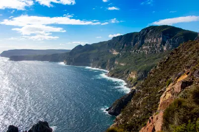 Wide view of the towering sea cliffs and rugged coastline at Cape Raoul, Tasmania.
