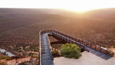 Sunrise illuminates the elevated Kalbarri Skywalk above the Murchison River gorge.