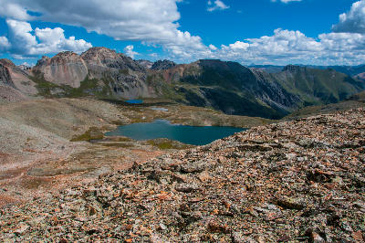 High alpine view of Island Lake basin with emerald lake and rocky terrain, San Juan Mountains, Colorado.