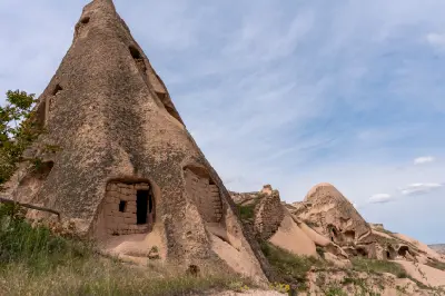 Tall fairy chimney with rock-cut pigeon houses in Pigeon Valley, Cappadocia, Turkey.