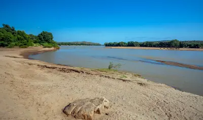 Wide channel of the Limpopo River with sandy banks along the South Africa–Zimbabwe border.