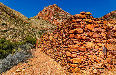 Historic stone convict ruins beside Swartberg Pass near Prince Albert in the rugged Klein Karoo mountains of South Africa.