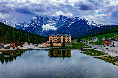 Famous lakeside building on Lago di Misurina, with Dolomite mountain peaks rising in the background near Misurina, Italy.