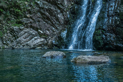 Waterfall flowing into a rocky mountain pool at Rust-en-Vrede Waterfall near Oudtshoorn in the Western Cape of South Africa.