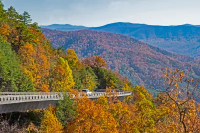 Foothills Parkway crossing autumn forested ridges in the Great Smoky Mountains with colourful fall foliage and layered blue mountains.