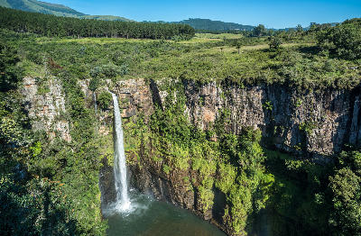 Mac Mac Falls dropping into a deep gorge surrounded by towering cliffs and escarpment vegetation near Sabie, Mpumalanga, South Africa.