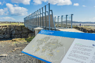 Interpretive sign showing tectonic plates beside the Bridge Between Continents spanning the Álfagjá rift on the Reykjanes Peninsula, Iceland.