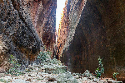 Narrow sandstone passage inside Wolfberg Crack in the Cederberg Wilderness, with towering rock walls and boulders along the hiking route near Sanddrif.