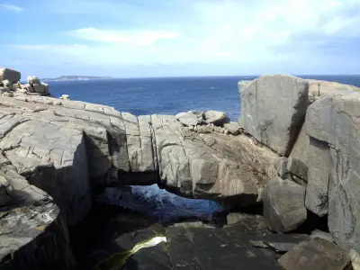 Natural Bridge surrounded by granite rock and the Southern Ocean in Torndirrup National Park near Albany, Western Australia.