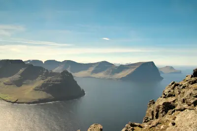 Cliff-edge view from Villingardalsfjall over the North Atlantic toward Borðoy, Kunoy, and Kalsoy islands in the Faroe Islands.