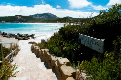Coastal Walk Trail entrance at Hellfire Bay overlooking turquoise water and granite hills in Cape Le Grand National Park, Western Australia.