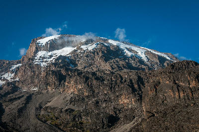 View of Kibo's southern cliffs and glaciers above Barranco Camp at 3,960 m on Mount Kilimanjaro, Tanzania.