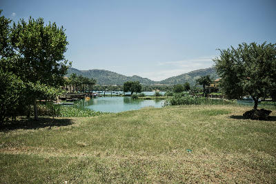 Views across canals and lakeside homes at Westlake Country and Safari Estate on Hartbeespoort Dam, framed by the Magaliesberg mountains, South Africa.