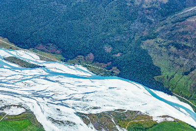 Aerial view of the braided Dart River flowing across pale gravel flats near Kinloch and Glenorchy, Otago, South Island, New Zealand.