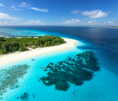 Aerial view of a pristine white sandbank surrounded by turquoise waters near Mnemba Atoll, Zanzibar, Tanzania.