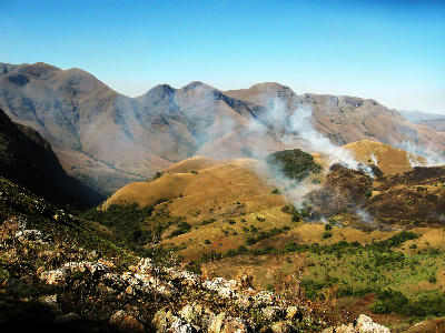 Grassland fire and mountain ridges in the Makhonjwa Mountains near Barberton, South Africa.