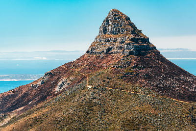 Lion’s Head mountain with visible hiking trail and ocean backdrop in Cape Town, South Africa.