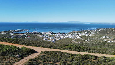 Panoramic view of St Helena Bay showing the harbour, coastal settlements, shrub-covered hills and the sheltered waters of the Atlantic Ocean.