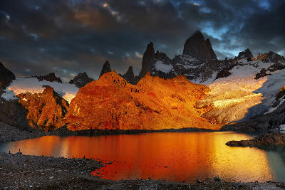 Golden sunrise over Laguna de los Tres with Mount Fitz Roy reflected in the lake, Patagonia, Argentina.