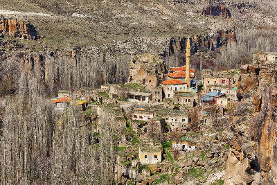 Belisırma Village and mosque surrounded by rocky cliffs in Ihlara Valley, Turkey.