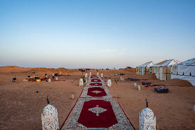 Traditional desert camp tents and carpets in the Erg Chebbi dunes near Merzouga, Morocco.