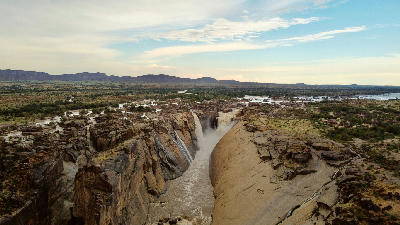 Aerial view of Augrabies Falls and the Orange River cutting through a deep granite canyon in Augrabies Falls National Park, South Africa.