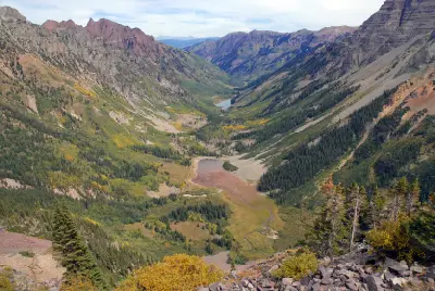 Maroon Creek Valley near Aspen Colorado showing alpine basin, winding stream, and surrounding mountain slopes in the Elk Mountains.