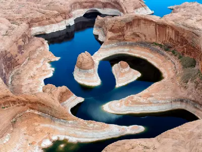 Aerial view Reflection Canyon Lake Powell curved sandstone formations low water levels Glen Canyon Arizona