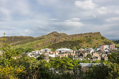 Arthur’s Seat and Salisbury Crags above Edinburgh with the Dugald Stewart Monument on Calton Hill.